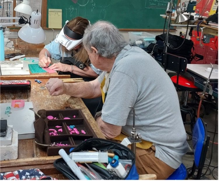 The ever-patient Bob Hanson leads Sarah Macres as she works on the wax form for her silver casting project.
